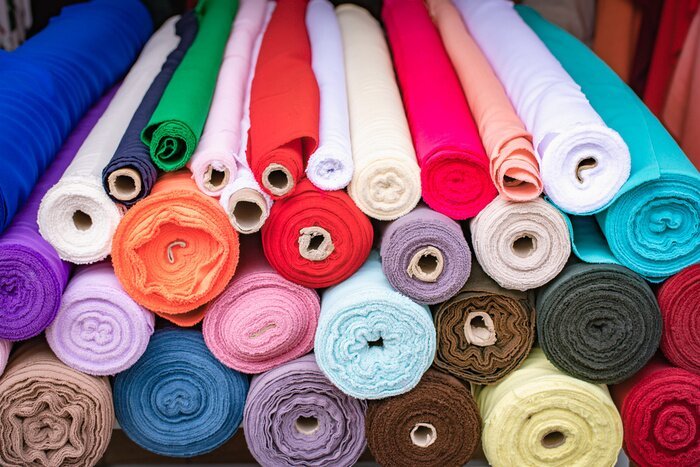 Real photo of colourful fabric rolls stacked for custom fabric development
